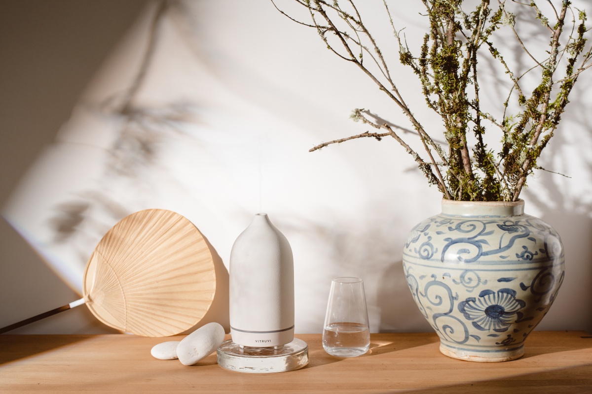 Vitruvi Aroma Diffuser, Uchiwa fan and flower arrangement