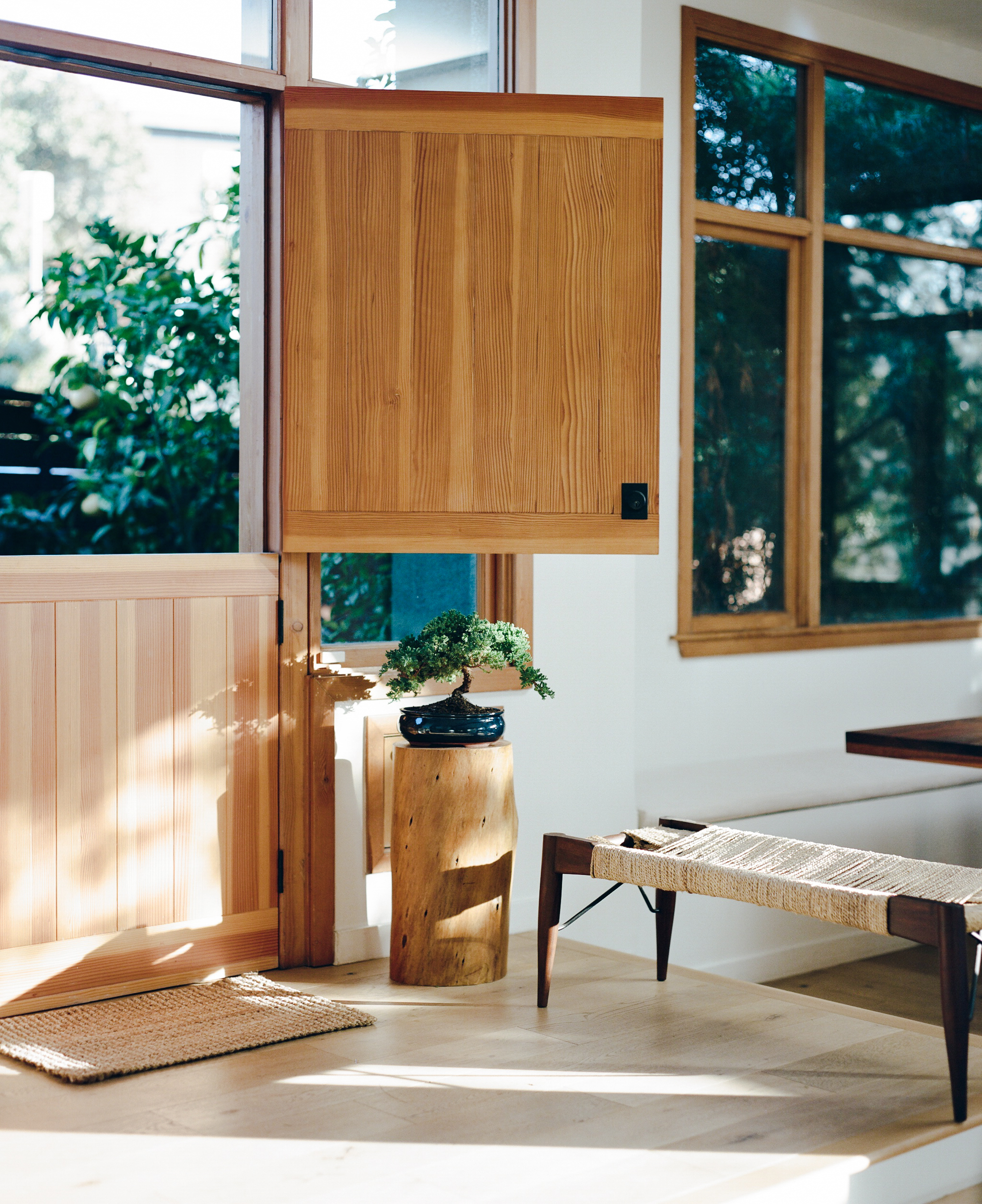 An entryway with a bench for sitting and storage.